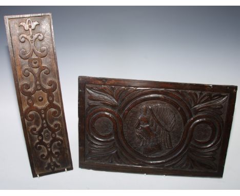 A 16th century oak Romayne type panel, carved in relief with a portrait roundel flanked scrolling acanthus, 41.5cm wide; an e