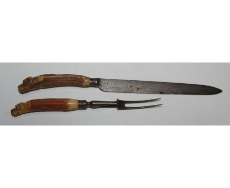 A Victorian novelty carving set, by Sansom &amp; Sons, comprising knife and fork, each stag antler haft carved as the head of