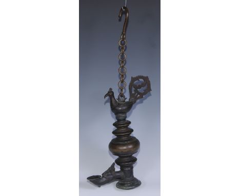 An Indian bronze temple lamp, cast with zoomorphic spout and crested by a peacock, 27cm high 