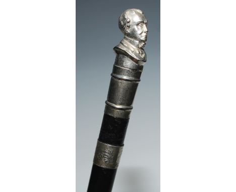 A novelty walking stick, the pommel cast as a portrait bust, ebonised cane, 85cm long, the silver ferule Birmingham 1917 