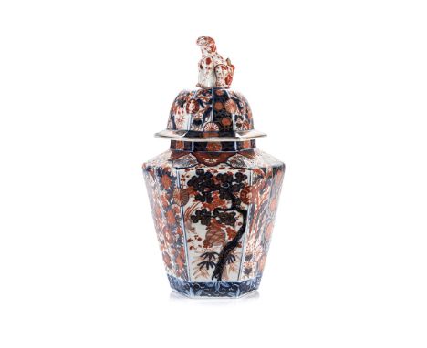 A JAPANESE HEXAGONAL IMARI VASE AND COVER, MEIJI, 1868 – 1912 covered overall with blossoming trees, flora, fauna and scrolli