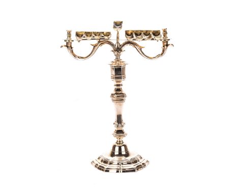 A POLISH BRASS OIL-BURNING HANUKAH LAMP, CIRCA 1850 on a shaped circular floriform base with a tripartite central column surm