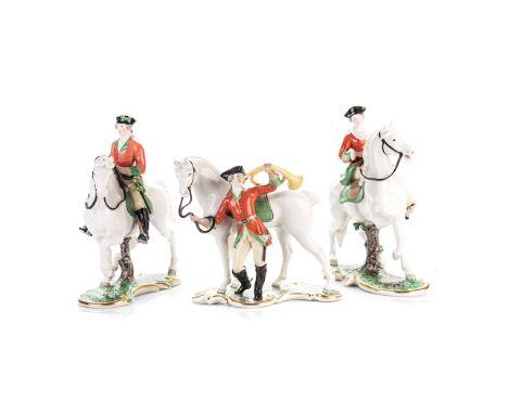 A GROUP OF  THREE NYMPHENBURG GLAZED HUNTING FIGURES naturalistically modelled, comprising: a lady on horseback, a gentleman 