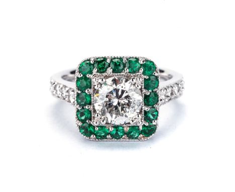 AN ART DECO STYLE DIAMOND AND EMERALD RING centered with a round brilliant-cut diamond weighing approximately 1.53cts, within