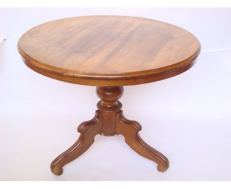 19th Century Continental walnut circular breakfast table, on baluster column support and tripod base. 