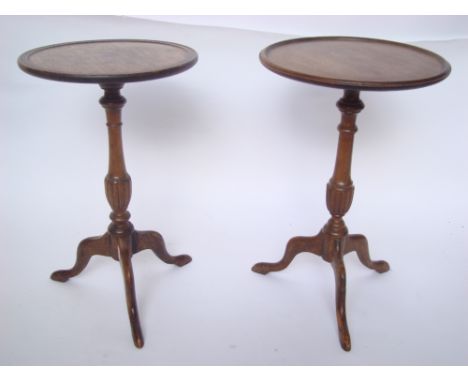 WITHDRAWN.  A near pair of reproduction mahogany low tripod wine tables. 