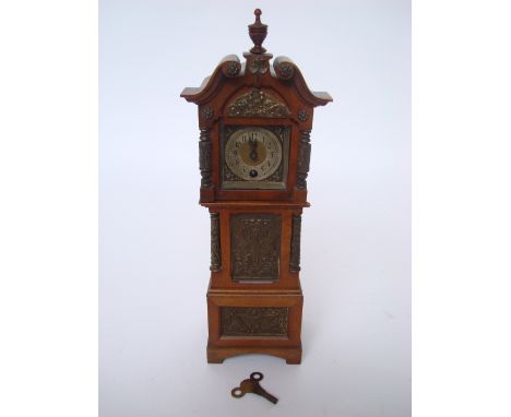 A late 19th Century German walnut and brass mounted novelty miniature longcase mantel clock, with brass cylinder movement sta