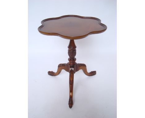 A modern reproduction George III style mahogany tripod occasional table, the scalloped edge top with moulded edge on turned a