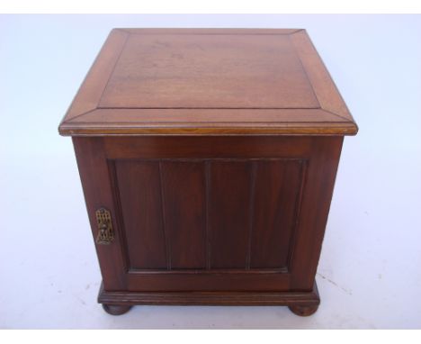 A late Victorian mahogany box commode with hinged lid and door to front, containing a ceramic pot and cover.