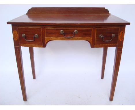 A late Victorian mahogany bow front side table, satinwood crossbanded strung and inlaid with marquetry oval patterae, the top