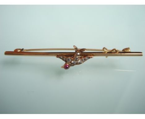 A late Victorian diamond set swallow brooch set with rose cut diamonds to body and cabochon ruby to head, on a 15 carat gold 