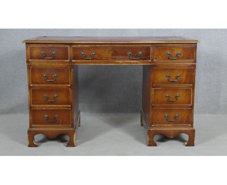 A Georgian style mahogany three section pedestal desk with inset leather top on shaped bracket feet. H.76.5 W.122.5 D.61.5cm 