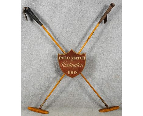 A vintage crossed Polo mallets match trophy from Hurlington, 1908. With wooden painted shield with inscription. H.115 W.82 