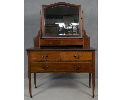 An Edwardian mahogany and satinwood with ebony strung dressing chest fitted with bevelled swing mirror. H.155 W.107 D.51cm 