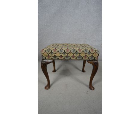 A mid century Georgian style mahogany stool in tapestry upholstery on cabriole supports. H.49 W.55 D.42cm 