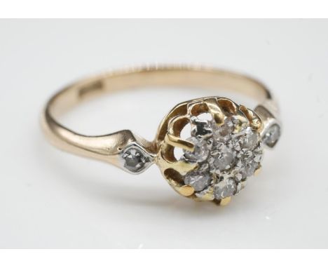 An antique old cut diamond and 18 carat yellow gold cluster ring. Set to centre with a round old cut diamond with an approxim