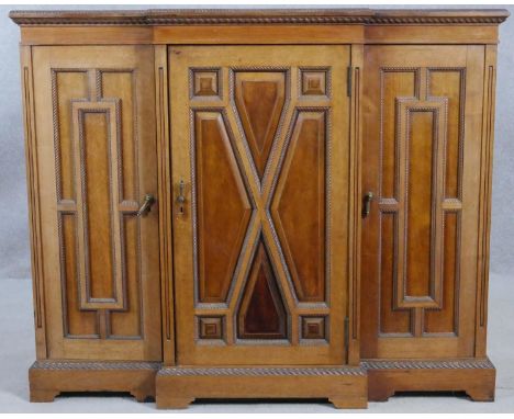 An early 20th century mahogany dwarf breakfront credenza with gadrooned edges and beading all around resting on shaped bracke