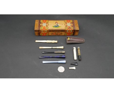 A box of cheroot holders and lighter. A collection of eight cheroot holders and a pocket lighter. Including a Chinese 19th ce