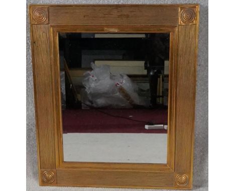 A wall mirror in reeded gilt frame. H.69 W.58cm 