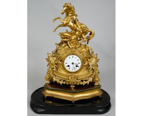 A 19th century French ormolu cased mantel clock with white enamel dial and eight day movement on carved giltwood stand, with 