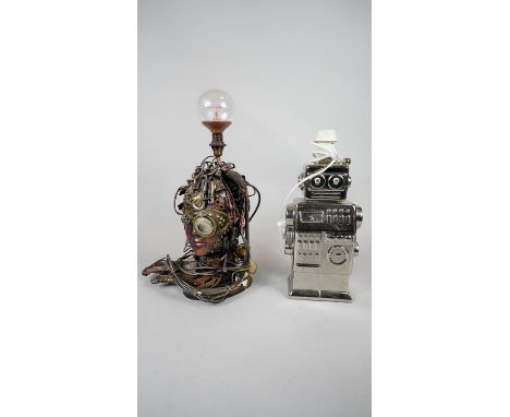 A table lamp in the form of a toy robot and a lamp base in the shape of an androids head. H.41 W.18 