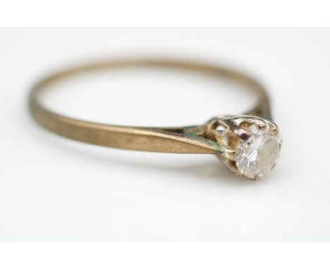 A vintage 9 carat yellow gold diamond solitaire ring. Set with a round brilliant diamond with an approximate carat weight of 