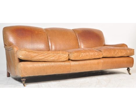 A stunning 20th century retro vintage Howard style brown leather three seat sofa settee having a triple bloomed and cushioned