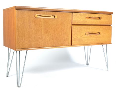 A vintage retro 20th century teak&nbsp; sideboard credenza of small proportions having a series of drawers with lozenge oval 