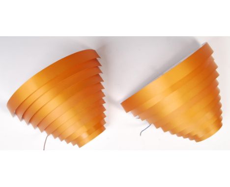 A pair of contemporary designer ' Eclipse ' wall light / sconces having curved sheet aluminium graduating in size to create a