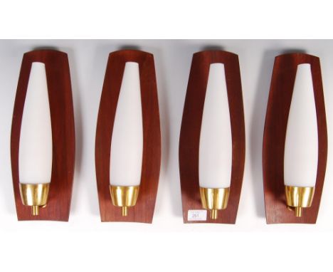 A set of four retro vintage wall lights / sconces each comprising of teak backed wall fixings having gilt brackets and milk g
