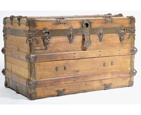 A vintage 20th century wooden and metal bound stained pine trunk / chest with metal adornments, fixings, rivets, clasps and h