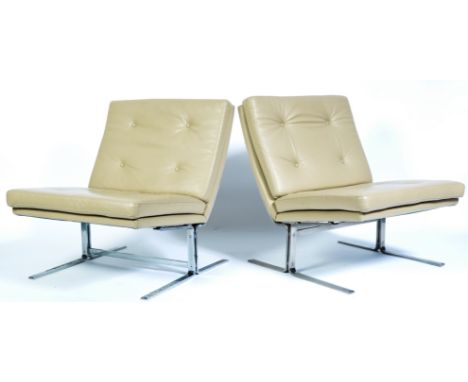 A pair of 20th century retro vintage easy / lounge chairs comprising of a chrome plated steel frame with supporting a cushion