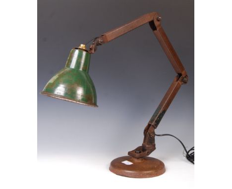 A early to mid 20th century vintage industrial workman's / factory articulated desk / table lamp fitted to a cast metal base 