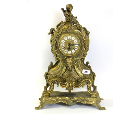A large gilt brass mantle clock with porcelain numerals, H. 52cm.