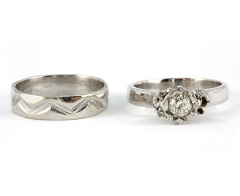 An 18ct white gold diamond set solitaire ring, together with a white metal (tested 18ct gold) wedding band, (M).