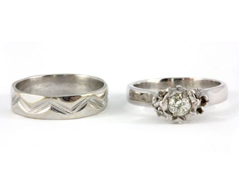 An 18ct white gold diamond set solitaire ring, together with a white metal (tested 18ct gold) wedding band, (M).