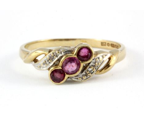 A 9ct yellow gold ruby and diamond set ring, (L.5).