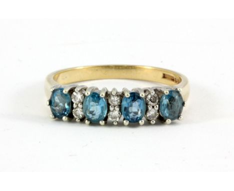 A 9ct yellow gold blue topaz and diamond set half eternity ring, (M.5).