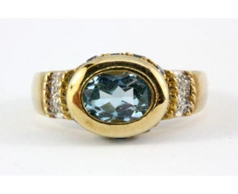 A 9ct yellow gold ring set with blue topaz and diamonds, (P.5).