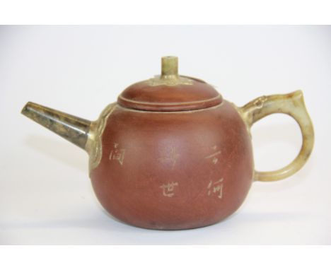 A Chinese Yixing terracotta teapot with jade spout and handle, spout to handle 18cm.