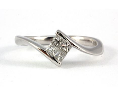 An 18ct white gold princess cut diamond set ring, (L).