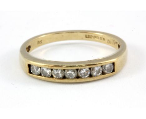 A 9ct yellow gold diamond set half eternity ring, (L).