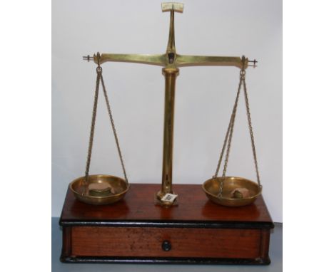 A 19th Century mahogany and brass balance scale and weights, W. 38cm, H. 46cm.