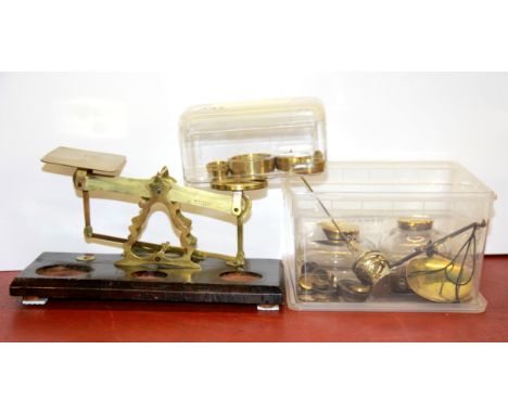 An antique scale and weights, with two inkwells and an additional balance scale and small weights.