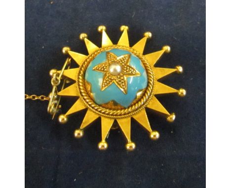 A gold coloured and enamel brooch pendant star design
