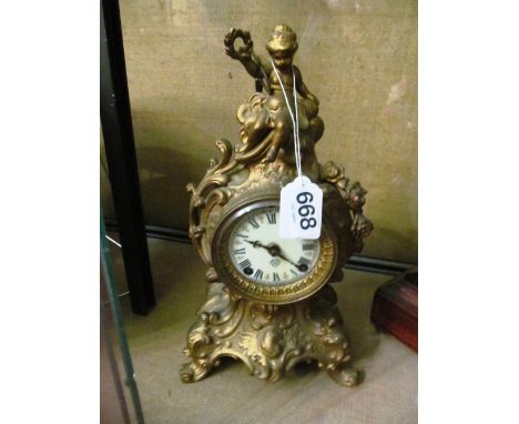 A 19th Century gilt clock with cherub surmount and with Ansonia Clock Co. movement
