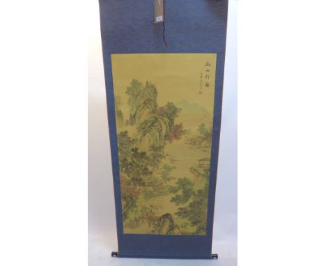 A Chinese scroll depicting figures on a journey through mountains. 