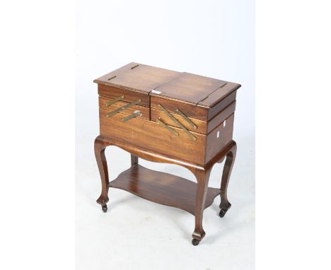 A early 20th century sewing trolley and a Japanese style bobbin box. The trolley with a hinged top and undertier, on casters,