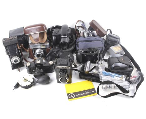 A collection of assorted vintage film and digital cameras. Including a Canon Power Shot A620 digital and Spocket Rocket Panor