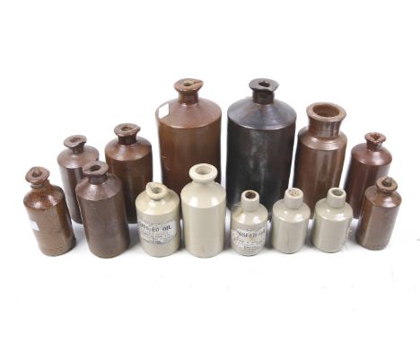A collection of vintage stoneware bottles. Of various colours and sizes, some with the paper labels marked 'Linseed Oil', Max
